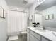Full bathroom with neutral white vanity, framed artwork, and shower at 1067 Plantation Ln, Davenport, FL 33896