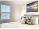 Bright bedroom featuring a driftwood style headboard, decorative pillows, and beach themed artwork for a tranquil feel at 1067 Plantation Ln, Davenport, FL 33896