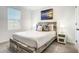 This bedroom features a driftwood style bed frame, beach themed artwork, and a bright, airy feel from the natural light at 1067 Plantation Ln, Davenport, FL 33896