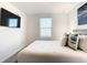 Cozy bedroom with a flatscreen TV, bright window, and serene wall art at 1067 Plantation Ln, Davenport, FL 33896