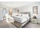 Sunlit bedroom with a large bed, modern decor, and an ensuite bathroom for added convenience at 1067 Plantation Ln, Davenport, FL 33896