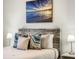 Bedroom featuring a comfortable bed, stylish lamps, and eye-catching artwork at 1067 Plantation Ln, Davenport, FL 33896