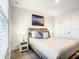 Well-lit bedroom features a soft bed, nightstands, and beach themed decor at 1067 Plantation Ln, Davenport, FL 33896