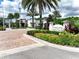 Entrance to the community's amenity center featuring well-maintained landscaping and a sign at 1067 Plantation Ln, Davenport, FL 33896