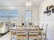 Cozy dining area with a view of the lake, features modern decor and ample natural light for gatherings at 1067 Plantation Ln, Davenport, FL 33896