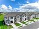 Modern townhomes boasting sleek exteriors, driveways, and well-manicured lawns at 1067 Plantation Ln, Davenport, FL 33896