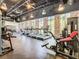 Bright gym with large windows, brick accent wall, treadmills, weight machines and high ceilings at 1067 Plantation Ln, Davenport, FL 33896