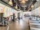 Gym featuring multiple treadmills and weight machines with natural light and colorful mural at 1067 Plantation Ln, Davenport, FL 33896