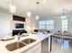 Open concept kitchen with dining and living room views and modern pendant lighting at 1067 Plantation Ln, Davenport, FL 33896