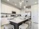 Stylish kitchen island with seating, quartz countertop, stainless appliances, and pendant lighting for a modern space at 1067 Plantation Ln, Davenport, FL 33896