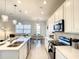 Bright kitchen features white cabinets, stainless steel appliances, and an open layout, perfect for modern living at 1067 Plantation Ln, Davenport, FL 33896