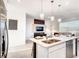 Modern kitchen with stainless steel appliances, countertops, and an open layout at 1067 Plantation Ln, Davenport, FL 33896
