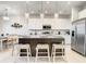 Contemporary kitchen design featuring a central island with seating and modern appliances at 1067 Plantation Ln, Davenport, FL 33896