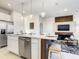 Open concept kitchen with stainless steel appliances and integrated living room view at 1067 Plantation Ln, Davenport, FL 33896