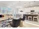 Bright and airy open-concept living area showcasing modern decor, a kitchen island, and a dining space at 1067 Plantation Ln, Davenport, FL 33896