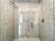 Modern shower stall with a glass door, chrome fixtures, and tiled walls at 1067 Plantation Ln, Davenport, FL 33896