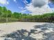 Outdoor sand volleyball court surrounded by green landscaping, ready for play at 1067 Plantation Ln, Davenport, FL 33896