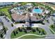 Stunning aerial view of community clubhouse with pools, volleyball, and parking at 1082 Blackwolf Run Rd, Davenport, FL 33896