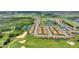 Aerial view of community near golf course, trees, and pond with fountain at 1082 Blackwolf Run Rd, Davenport, FL 33896