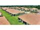 Another scenic aerial view of homes with screened lanais, green lawns, and mature landscaping at 1082 Blackwolf Run Rd, Davenport, FL 33896