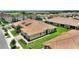This aerial view shows a property with lush greenery, landscaping and tile roof in a well kept community at 1082 Blackwolf Run Rd, Davenport, FL 33896