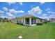 Lush backyard featuring a screened-in lanai, providing a relaxing outdoor space at 1082 Blackwolf Run Rd, Davenport, FL 33896