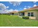 View of a well-maintained backyard, showcasing the home's exterior and landscaping at 1082 Blackwolf Run Rd, Davenport, FL 33896