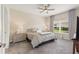 Relaxing bedroom features soft gray carpet, ceiling fan, and sunny window at 1082 Blackwolf Run Rd, Davenport, FL 33896