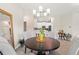 Inviting dining room with a round table, seating for four, and view to the kitchen area with white cabinets at 1082 Blackwolf Run Rd, Davenport, FL 33896