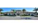 Charming community clubhouse featuring palm trees, lush landscape and inviting entrance at 1082 Blackwolf Run Rd, Davenport, FL 33896
