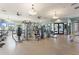 Spacious gym area with a variety of equipment including treadmills, weight machines, and a mirrored wall, promoting a healthy lifestyle at 1082 Blackwolf Run Rd, Davenport, FL 33896