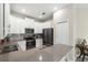 Well-lit kitchen with white cabinetry, stainless steel appliances, and countertops with a view of an adjacent dining space at 1082 Blackwolf Run Rd, Davenport, FL 33896