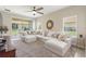 Bright living room with a large sectional sofa, ceiling fan, and sliding glass doors leading to an outdoor patio at 1082 Blackwolf Run Rd, Davenport, FL 33896