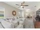 Open-concept living area with sectional sofa, ceiling fan, and a view of the dining area and natural light at 1082 Blackwolf Run Rd, Davenport, FL 33896