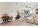 Bright living space with stylish furniture, a large television, and a view of the outdoor patio through sliding doors at 1082 Blackwolf Run Rd, Davenport, FL 33896