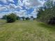The backyard features a well-maintained lawn, chain link fence, shed, and ample space for outdoor activities at 116 Talavera Ln, Kissimmee, FL 34758