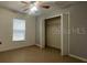 Bedroom featuring a ceiling fan, neutral walls, window for natural light, and closet at 116 Talavera Ln, Kissimmee, FL 34758