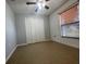 Bedroom with ceiling fan, neutral walls, double closet doors, and window for natural light at 116 Talavera Ln, Kissimmee, FL 34758