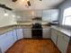 Traditional-style kitchen with light-colored cabinets and dark appliances at 116 Talavera Ln, Kissimmee, FL 34758