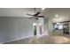 Open-concept living area with a ceiling fan, neutral walls, and lots of light at 116 Talavera Ln, Kissimmee, FL 34758