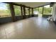 Spacious sunroom featuring tile flooring, multiple windows for natural light, and access to the backyard at 116 Talavera Ln, Kissimmee, FL 34758