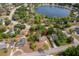 Aerial view of the home and the community, with lake view and lush greenery, showcasing the serene neighborhood at 120 W Minnehaha Ave, Clermont, FL 34711