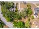 An aerial view showcasing the lush, mature landscaping and the layout of the neighborhood at 120 W Minnehaha Ave, Clermont, FL 34711
