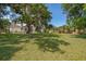 Large grassy backyard featuring a large tree with Spanish moss, providing shade and a scenic view at 120 W Minnehaha Ave, Clermont, FL 34711