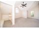 Bright bedroom with carpet, ceiling fan, vaulted ceiling, and closet with shelves at 120 W Minnehaha Ave, Clermont, FL 34711