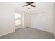 Neutral bedroom with carpet, ceiling fan, and closet space at 120 W Minnehaha Ave, Clermont, FL 34711