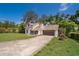 Charming two-story home features a front lawn, large trees and a two car garage at 120 W Minnehaha Ave, Clermont, FL 34711
