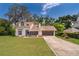 Charming two-story home features a front lawn, large trees and a two car garage at 120 W Minnehaha Ave, Clermont, FL 34711