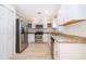 Bright kitchen features stainless steel appliances, granite countertops, and ample white cabinetry at 120 W Minnehaha Ave, Clermont, FL 34711