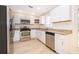 Bright kitchen features stainless steel appliances, granite countertops, and ample white cabinetry at 120 W Minnehaha Ave, Clermont, FL 34711